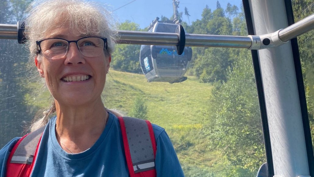 Image showing a lady enjoying a cable car ride at height