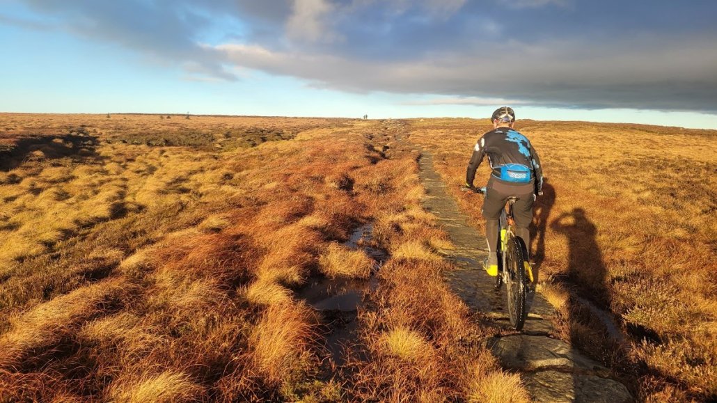 mountain biker riding along Derwent Edge in the Peak District