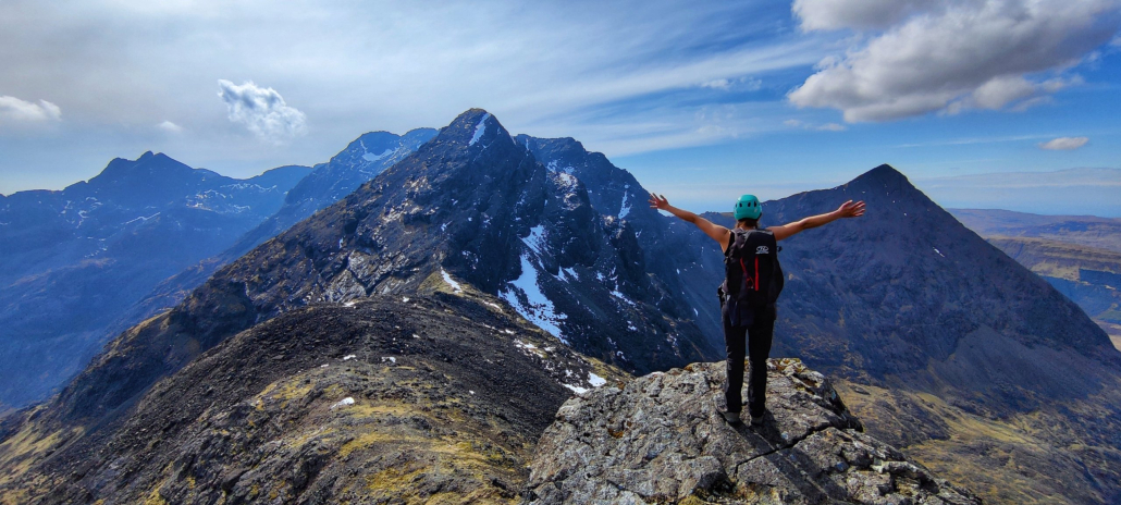 Cuillins Isle of Skye image showing a climber embracing the Cuillin Ridge in Scotland on the Isle Skye with her arms wide open